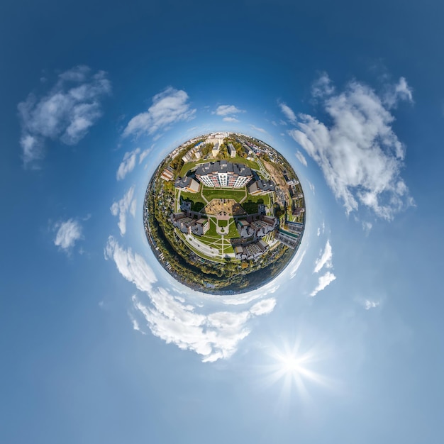 Photo tiny planet in sky with clouds overlooking old town urban development historic buildings and crossroads transformation of spherical 360 panorama in abstract aerial view