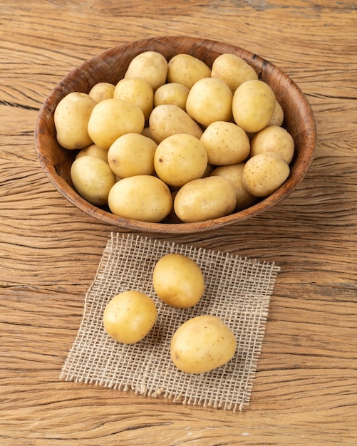 Tiny potatoes in a bowl over wooden table