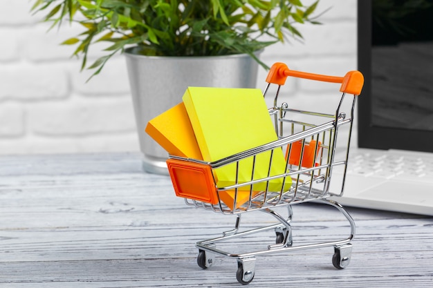 Tiny shopping cart and laptop