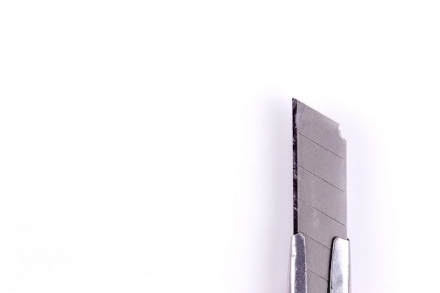 Tip of a stationery knife. Blade close up on white 