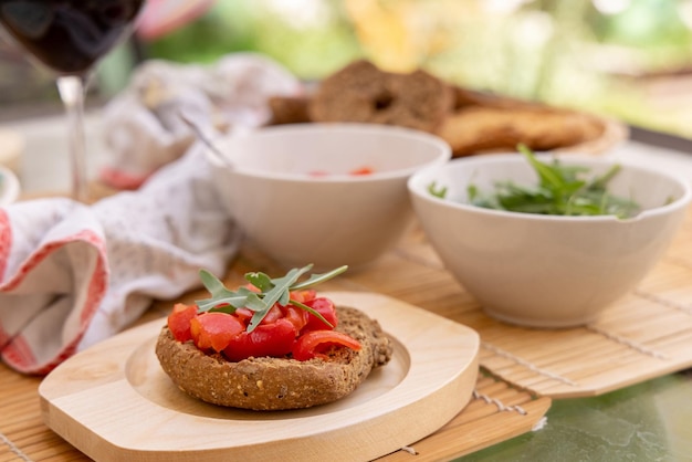 Tipical summer south Italian appetizer Friselle with cherry tomatoes oil and rucola served outdoor