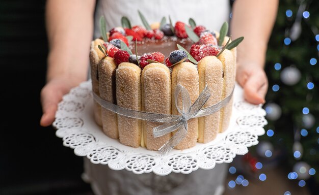 Tiramisu covered with chocolate glaze and decorated with berries