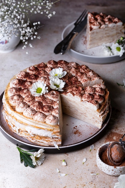 Tiramisu crepe cake with mascarpone and amaretto on a light\
background