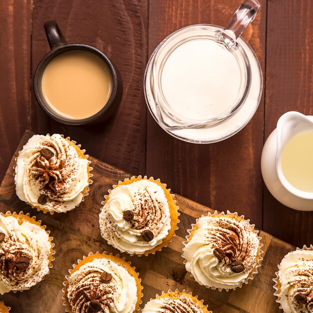 Tiramisu cupcakes decorated with cocoa powder and coffee grains 