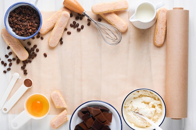 Tiramisu dessert ingredients for making dessert tiramisu
cooking italian food dessert tiramisu with all necessary
ingredients cocoa coffee mascarpone cheese on white stone
background mock up