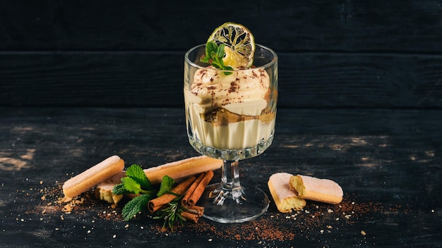 Tiramisu Dessert Top view On a black wooden background Copy space