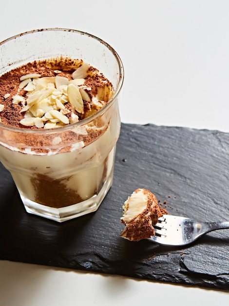 Tiramisu in glass traditional coffee flavored Italian dessert made of ladyfingers and mascarpone