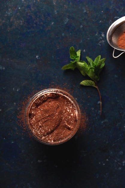 Tiramisu in glass with cocoa and mint