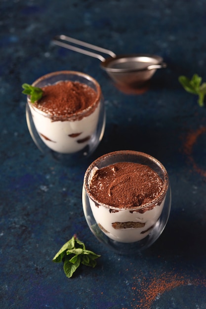 tiramisu with cocoa and mint in glasses