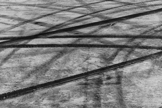 Tire track mark on asphalt tarmac road race track texture and background Abstract background black