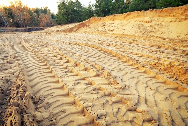 Tire tracks on the sand. Trace of wheels on the sand