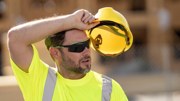 Tired builder hard work concept hispanic s worker builder on site construction american middle aged