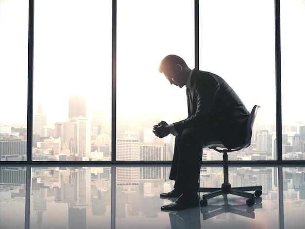 Tired businessman sitting in office