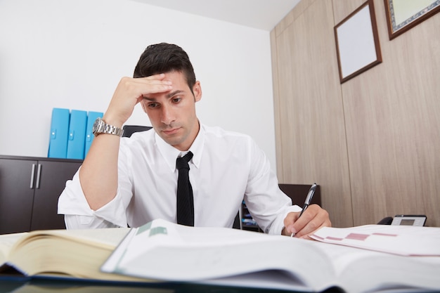 Tired businessman working in office