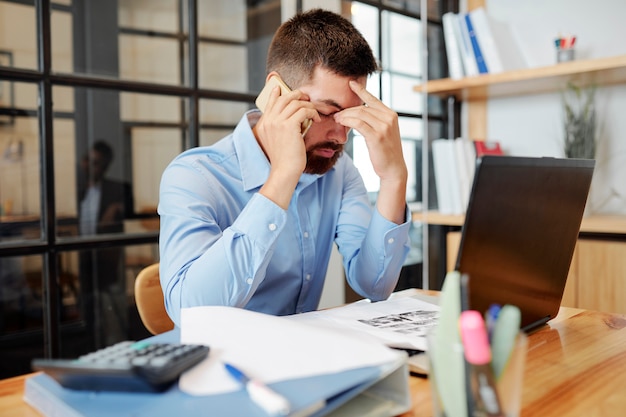 Tired businessman working at the table