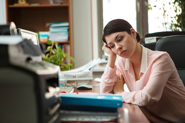 Tired businesswoman sleeping on the desk