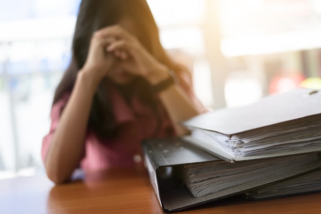 Tired businesswoman working with laptop computer.