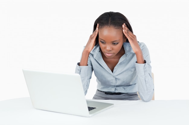 Tired businesswoman working with a laptop