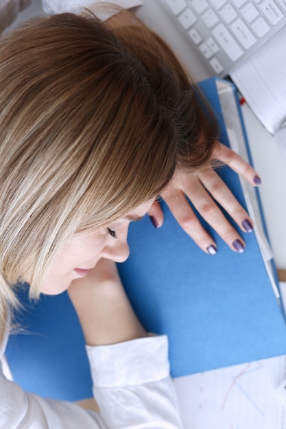 Tired businesswoman at workspace in office take nap