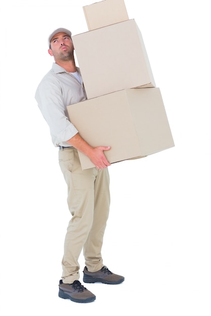 Photo tired delivery man carrying stack boxes