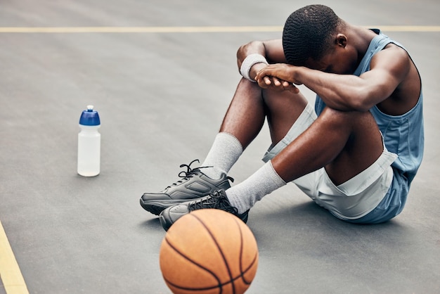 Tired depression or sad basketball player with training gear after game fail mistake or problem Depressed mental health and anxiety or stress sports athlete teenager man frustrated with results