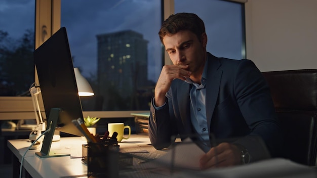 Tired executive work late in office exhausted financial manager massaging head