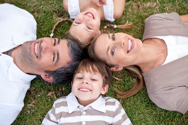 Tired family lying in a park