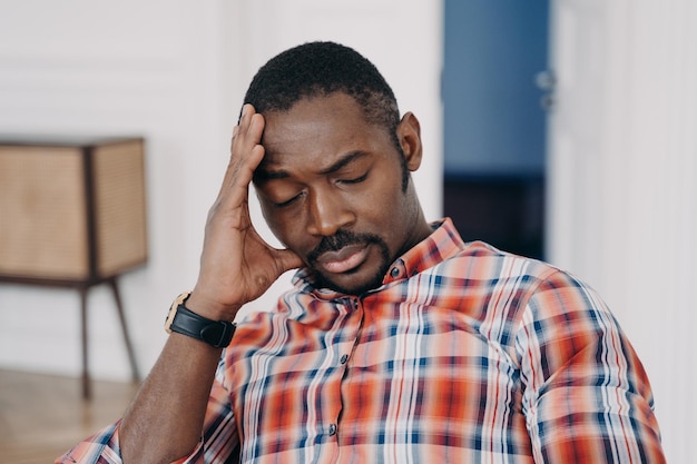 Photo tired frustrated african american man suffer from headache or migraine fatigue stress life crisis