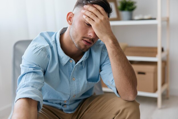 Tired frustrated young man reclines on hand closing eyes think
about difficult life decision bad news health problem sleepy guy
have depression need professional psychology help copy space for
ad