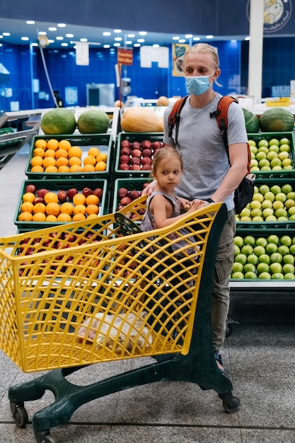 Tired kid girl in shopping cart