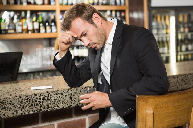 Tired man having a whiskey