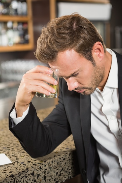 Tired man having a whiskey