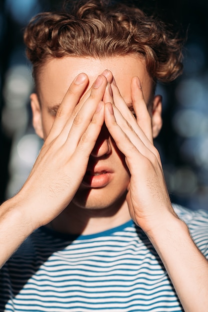 tired  man man covering face with hands
