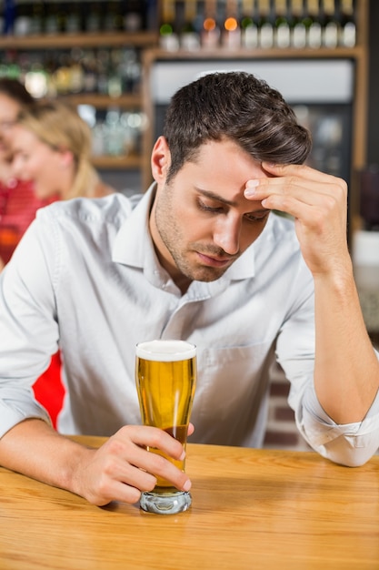 Tired man sitting in a bar