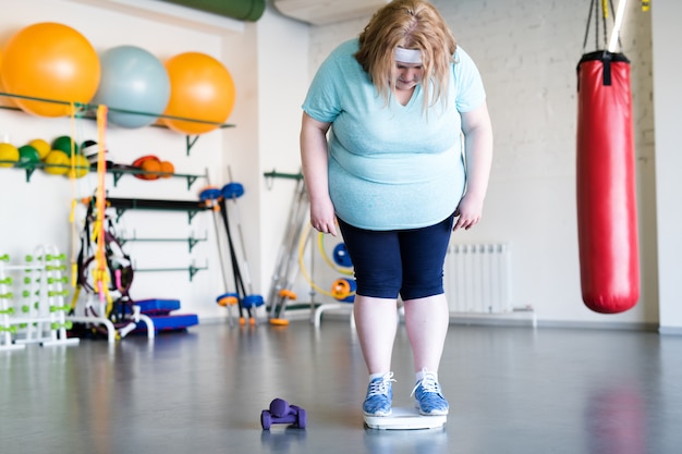 Tired Overweight Woman in Gym