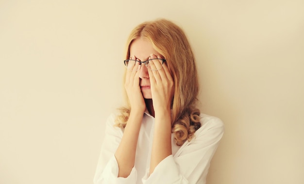 Tired overworked woman employee rubbing her eyes suffering from eye strain or headaches