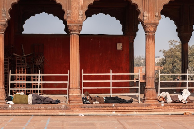 Tired people lie on the steps of the Jami Masjid Mosque in Delhi. India