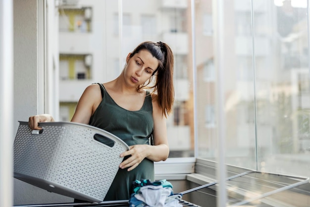 A tired pregnant wife does housework