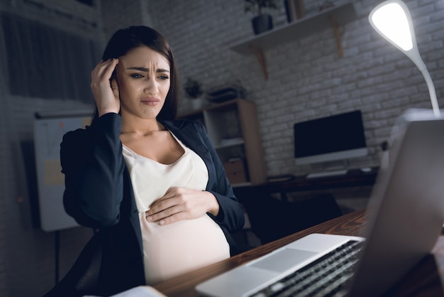 Tired Pregnant Woman Having Headache in Office