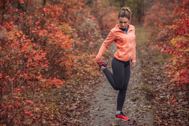 가을 숲에서 운동복에 피곤 된 스포츠 여자