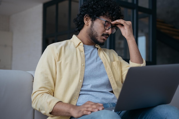 Tired stressed Indian businessman having headache Man fired from work Depression overwork concept