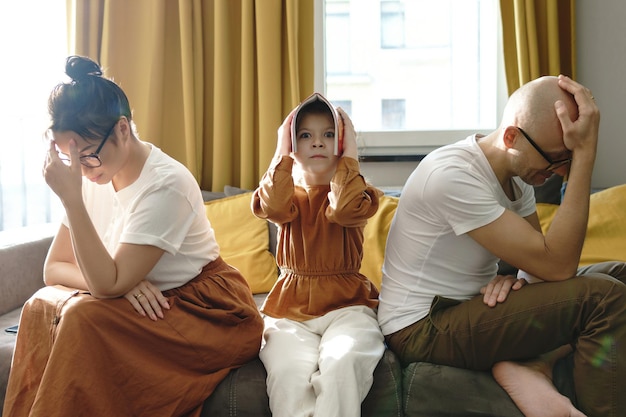 Tired and upset parents helping her daughter with a homework