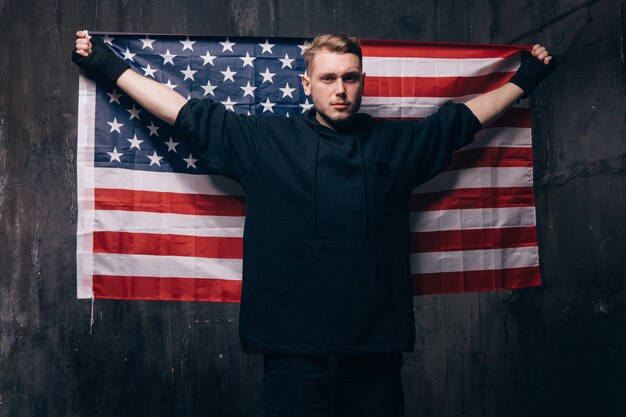 Tired USA patriot holds national flag