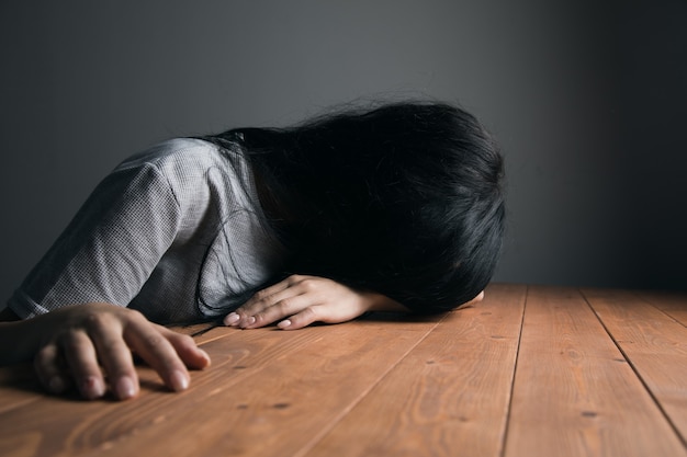 Tired woman laid her head on the table