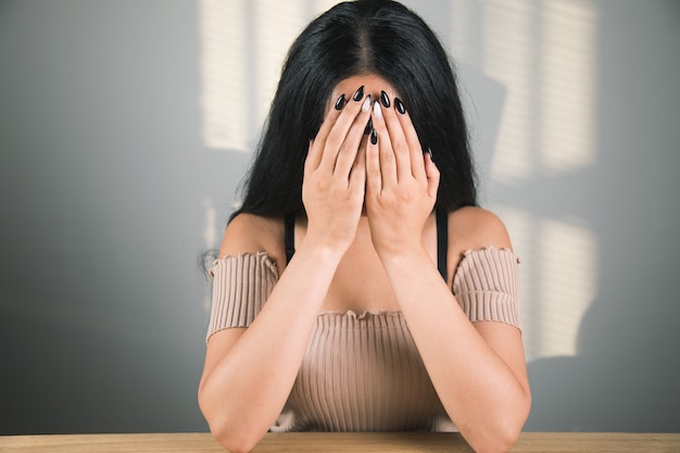 Tired woman sitting at the table