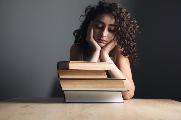 Tired woman with books