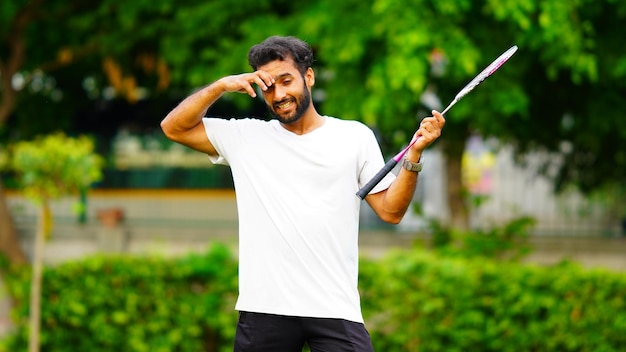 Tired young man playing badminton image hd outdoor shoot