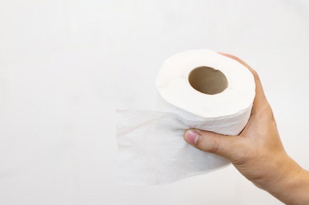 Tissue Close up of a man hand using detail of one single clean toilet paper roll on white background Hygiene Health care concept