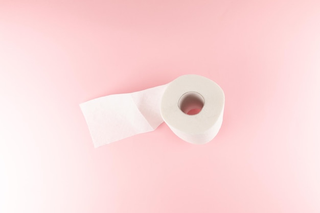 Tissue or toilet paper foroll on pink background with copy space wiping clean and top view