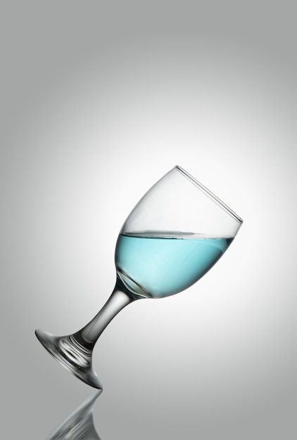 Tlted champange glass of water on white background